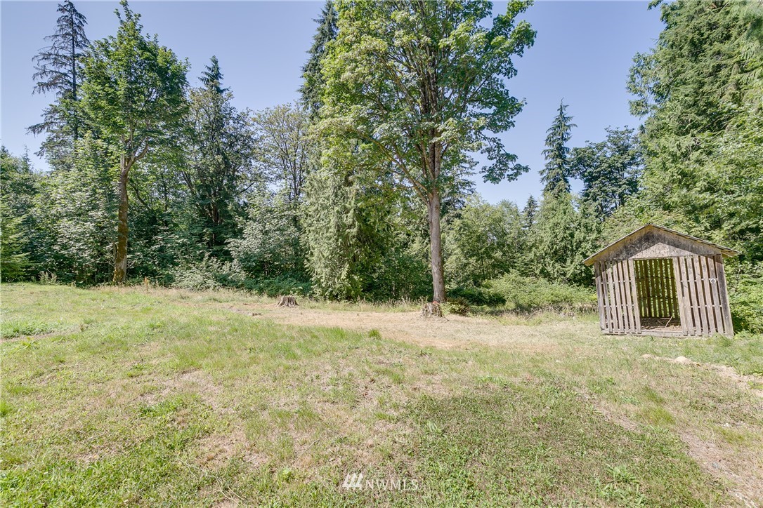 16623 Three Lakes Road Snohomish, WA 98290 - Photo 27 of 36 a view of a yard in front of a house with large trees