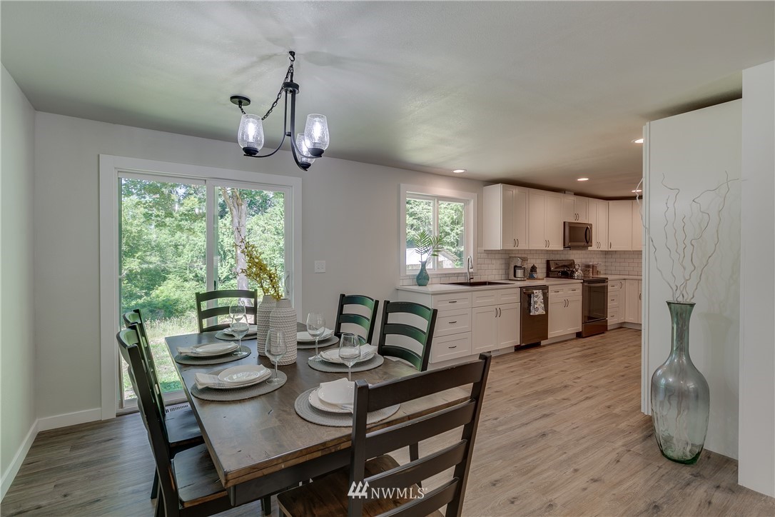 16623 Three Lakes Road Snohomish, WA 98290 - Photo 8 of 36 a living room with stainless steel appliances granite countertop furniture wooden floor and a kitchen view