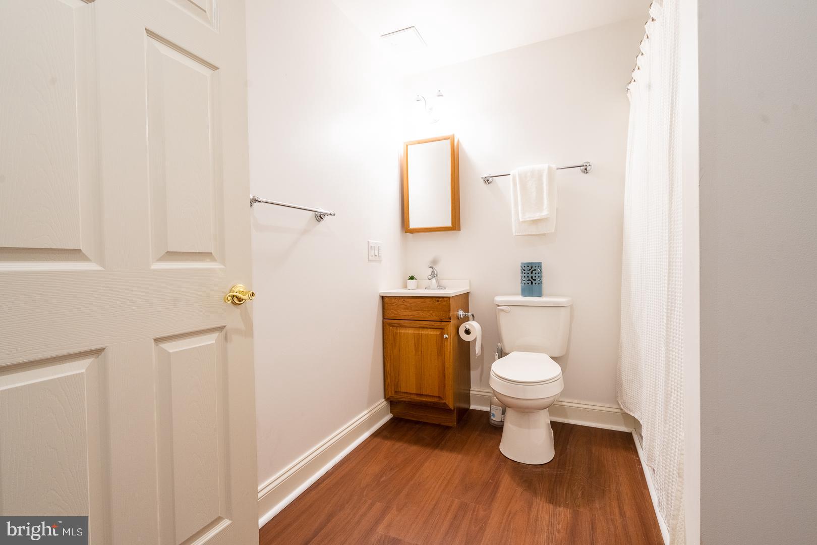 5705 Solomons Island Road St. Leonard, MD 20685 - Photo 37 of 46 a white toilet sitting next to a bathroom sink