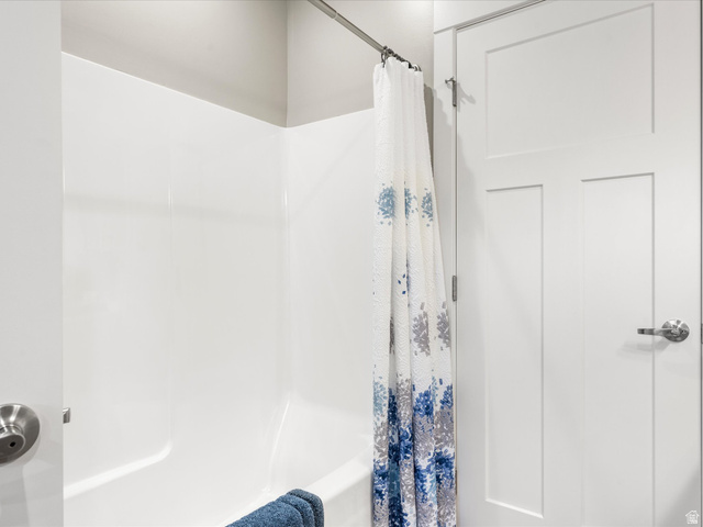 608 Fremont Road Fish Haven, ID 83287 - Photo 30 of 35 White bath/shower combination with a durable surround
