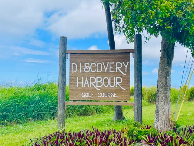 a sign broad in front of flowers