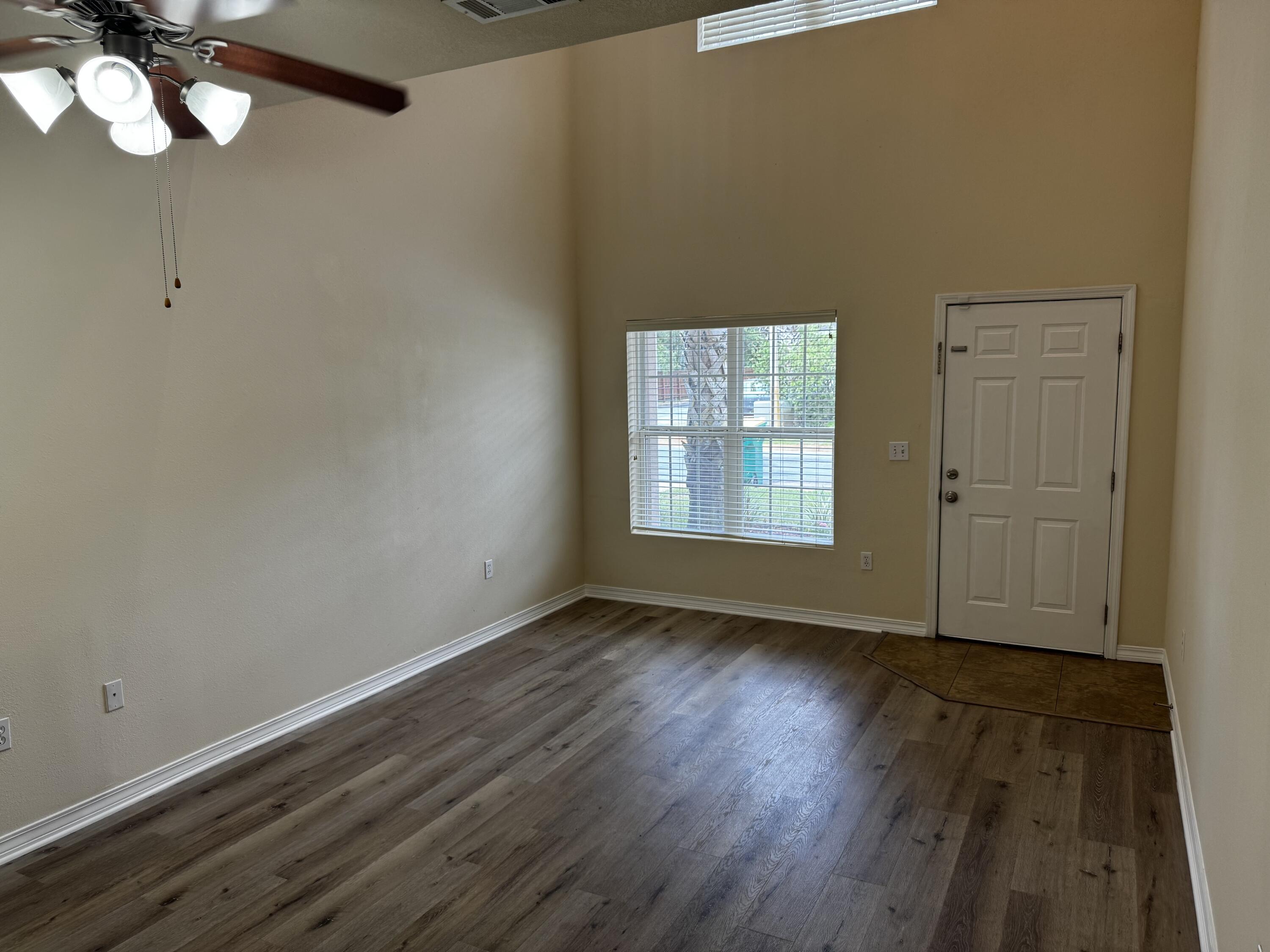 1512 Bentley Circle Fort Walton Beach, FL 32547 - Photo 2 of 12 a view of an empty room with wooden floor and a window