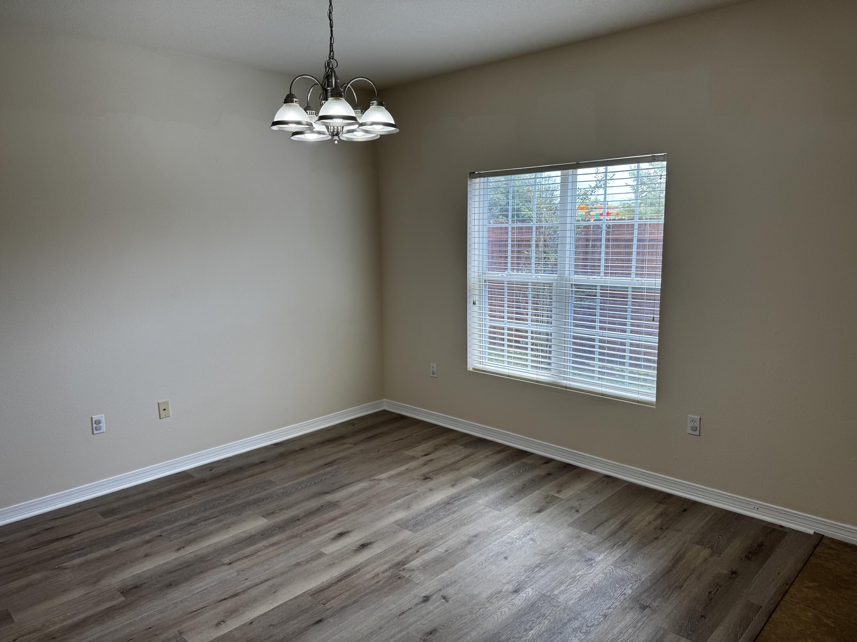 1512 Bentley Circle Fort Walton Beach, FL 32547 - Photo 6 of 12 a view of a room with wooden floor and a chandelier