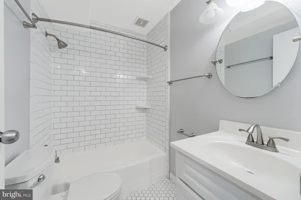 a bathroom with a sink a toilet and bathtub