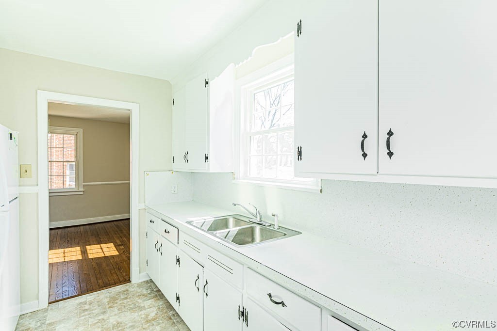 2317 New Berne Road Henrico, VA 23228 - Photo 22 of 37 a kitchen with granite countertop white cabinets and white appliances