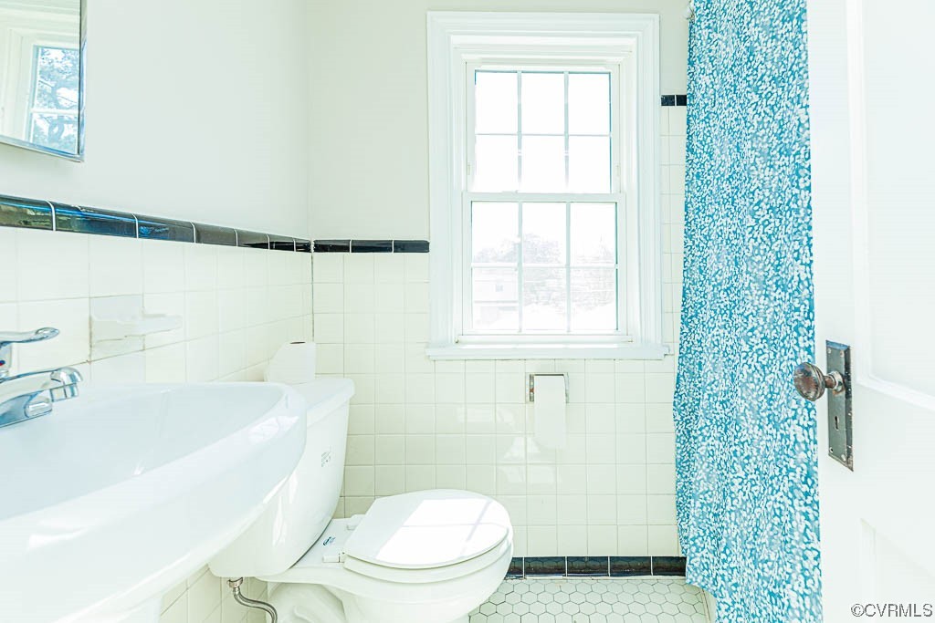 2317 New Berne Road Henrico, VA 23228 - Photo 27 of 37 a white toilet sitting next to a bath tub