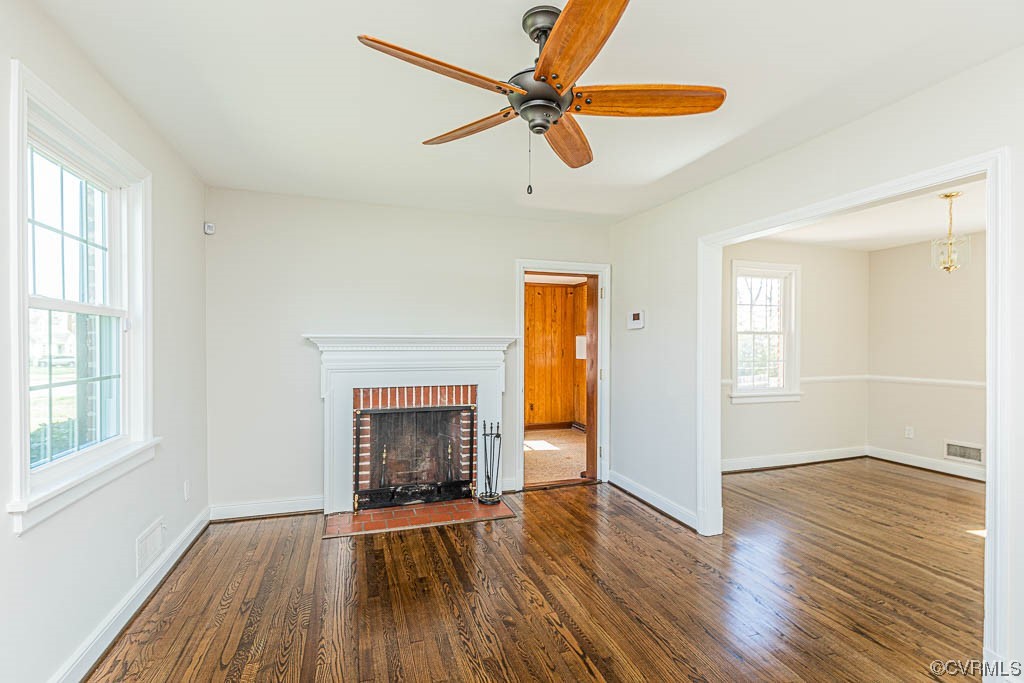 2317 New Berne Road Henrico, VA 23228 - Photo 10 of 37 an empty room with wooden floor a ceiling fan and windows