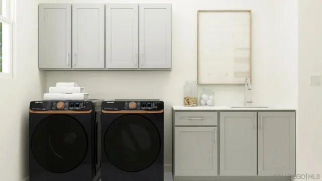 a utility room with sink dryer and washer