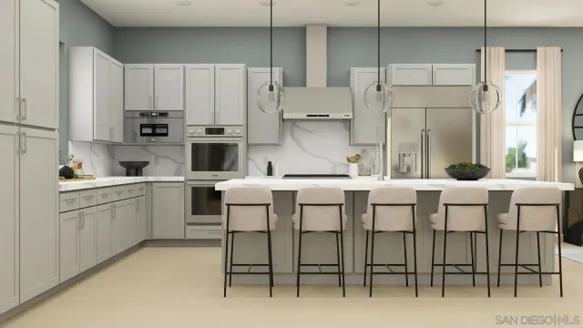 a kitchen with appliances cabinets and chair