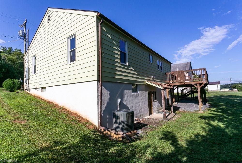 123 Hudson Street Elkin, NC 28621 - Photo 4 of 25 Side and rear view of home. Exterior entrance to basement. Heat pump 2017. Deck.