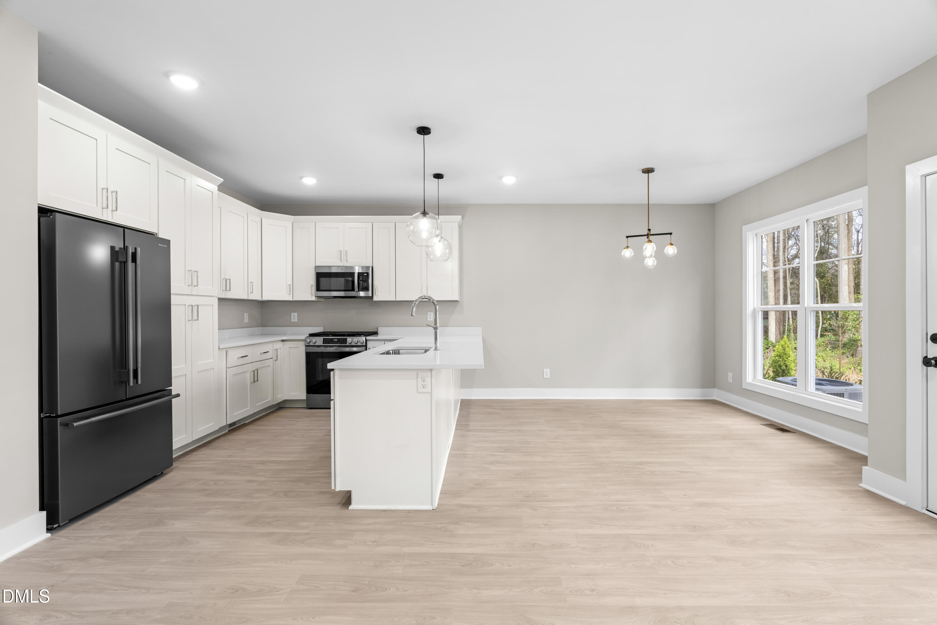 1024 Harper Road Raleigh, NC 27603 - Photo 8 of 36 a kitchen with a refrigerator a sink and a stove top oven