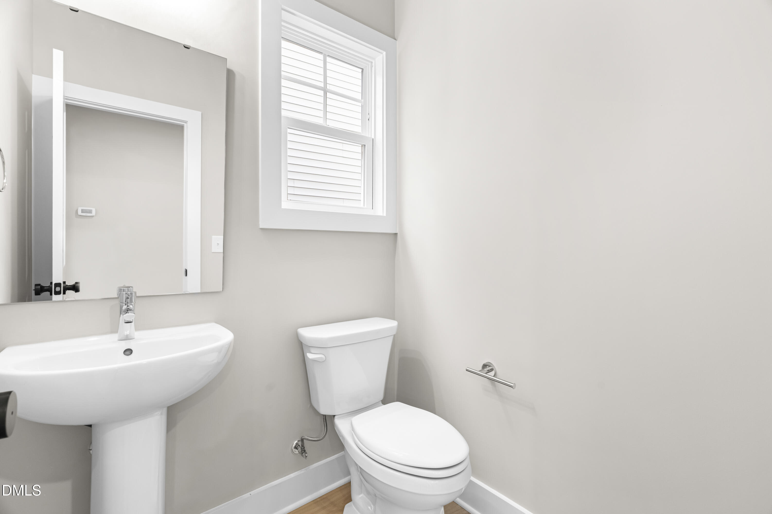 1024 Harper Road Raleigh, NC 27603 - Photo 15 of 36 a bathroom with a toilet a sink and a window