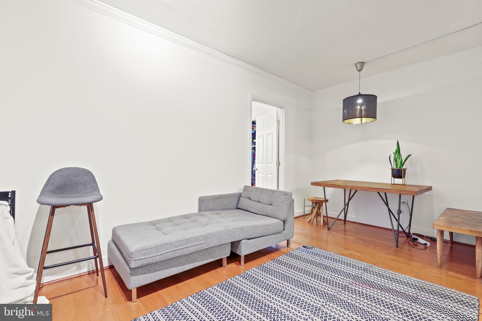 616 E Street Northwest, Unit 1007 Washington, DC 20004 - Photo 11 of 67 a living room with furniture and a table