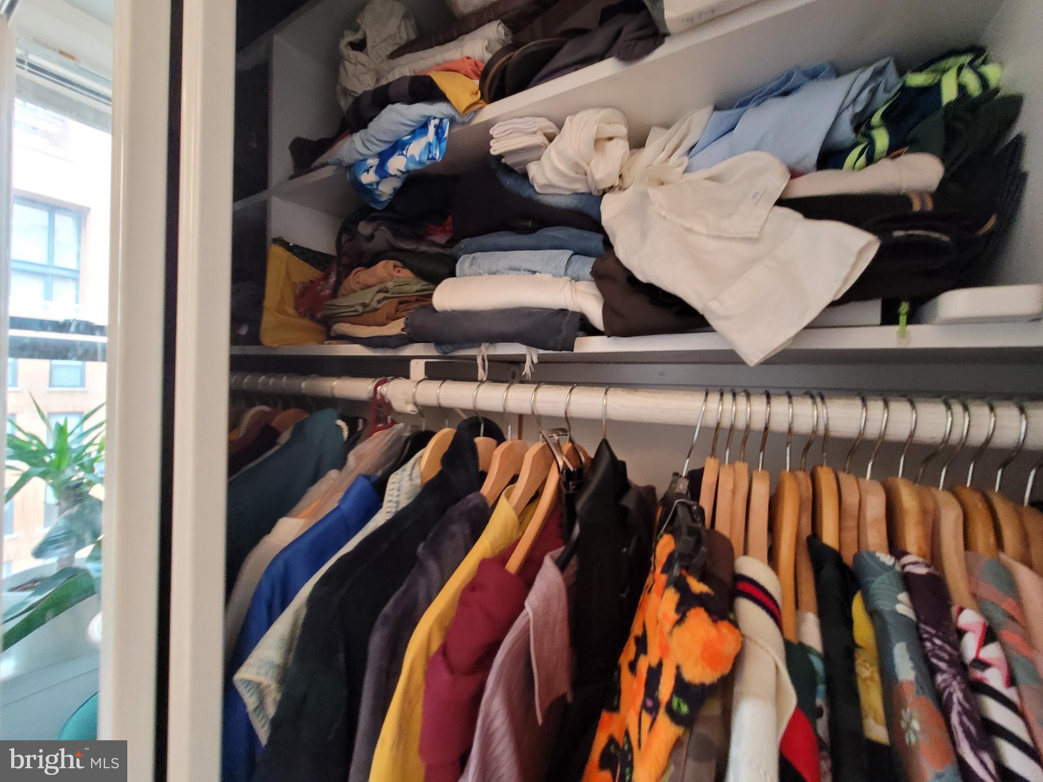616 E Street Northwest, Unit 1007 Washington, DC 20004 - Photo 23 of 67 a view of walk in closet with clothes and shoes