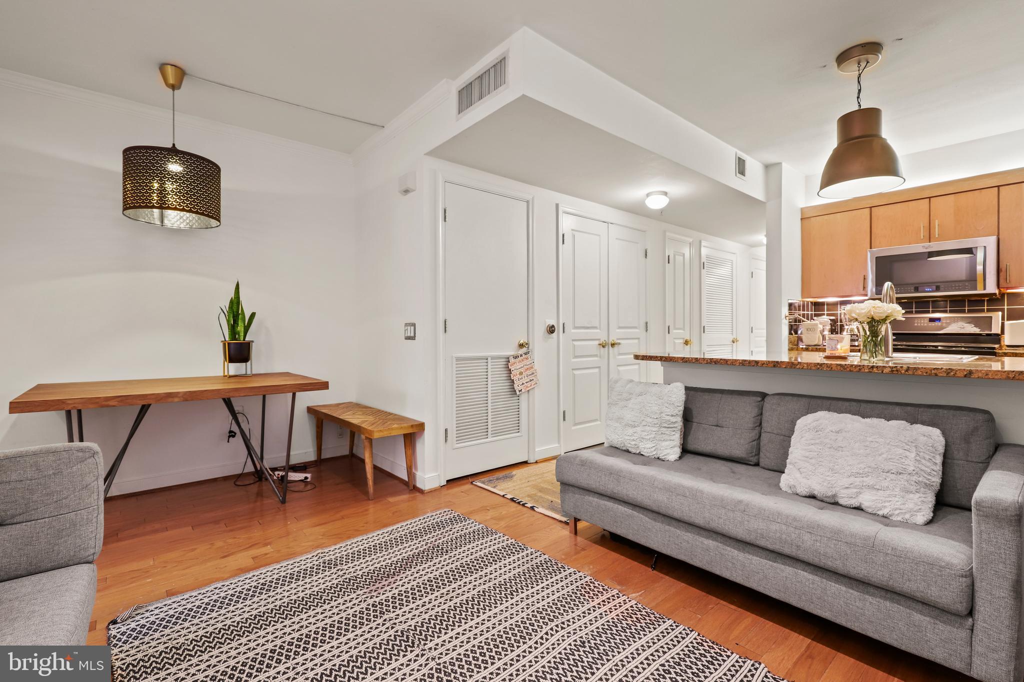 616 E Street Northwest, Unit 1007 Washington, DC 20004 - Photo 4 of 67 a living room with furniture and a flat screen tv