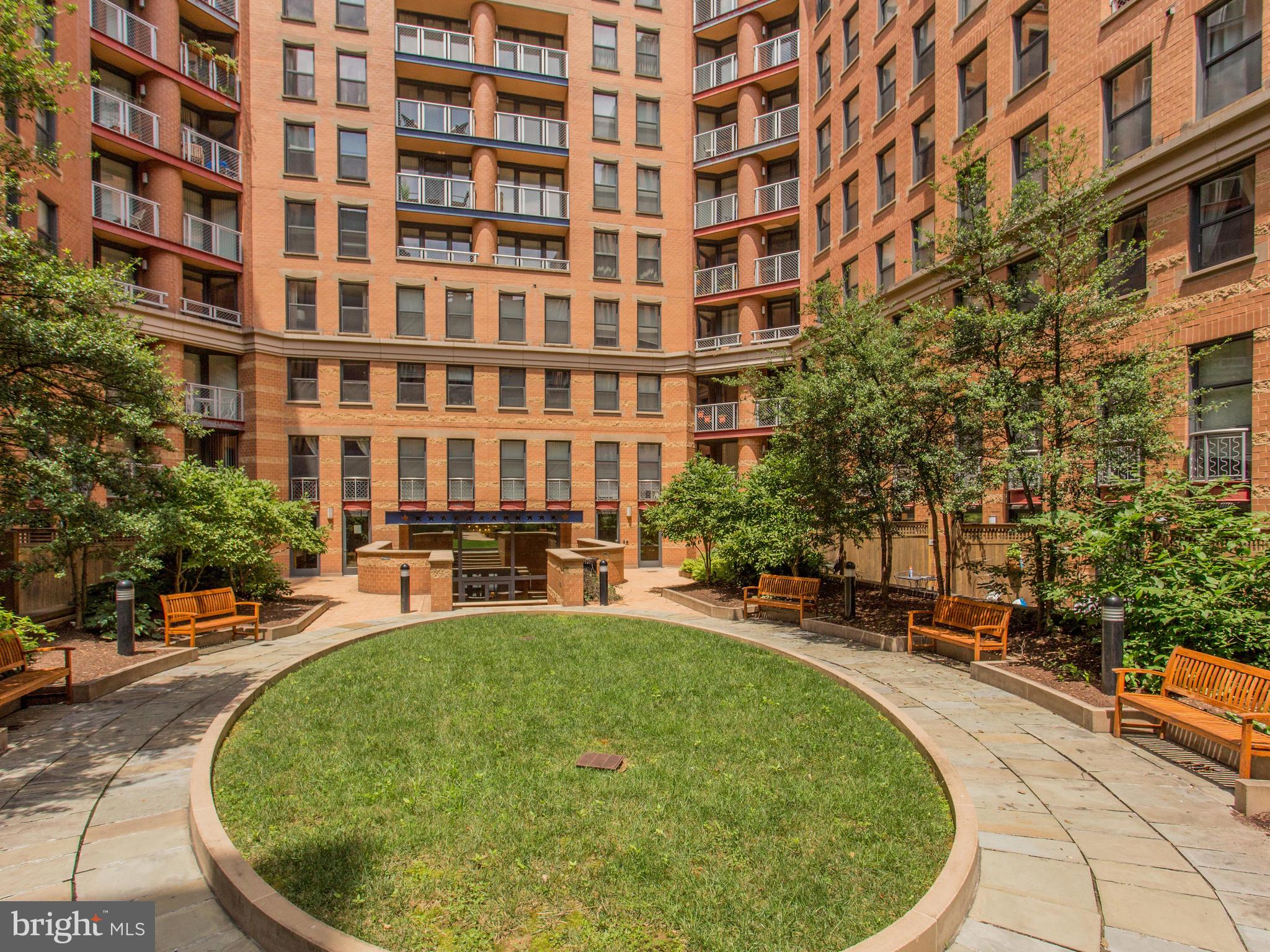 616 E Street Northwest, Unit 1007 Washington, DC 20004 - Photo 54 of 67 a swimming pool with outdoor seating and yard
