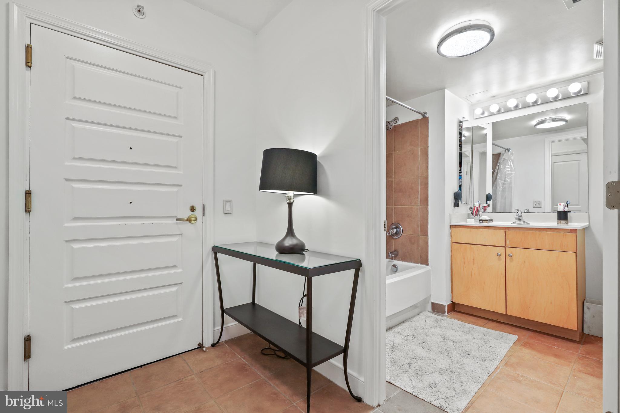 616 E Street Northwest, Unit 1007 Washington, DC 20004 - Photo 7 of 67 a bathroom with a sink vanity and a mirror