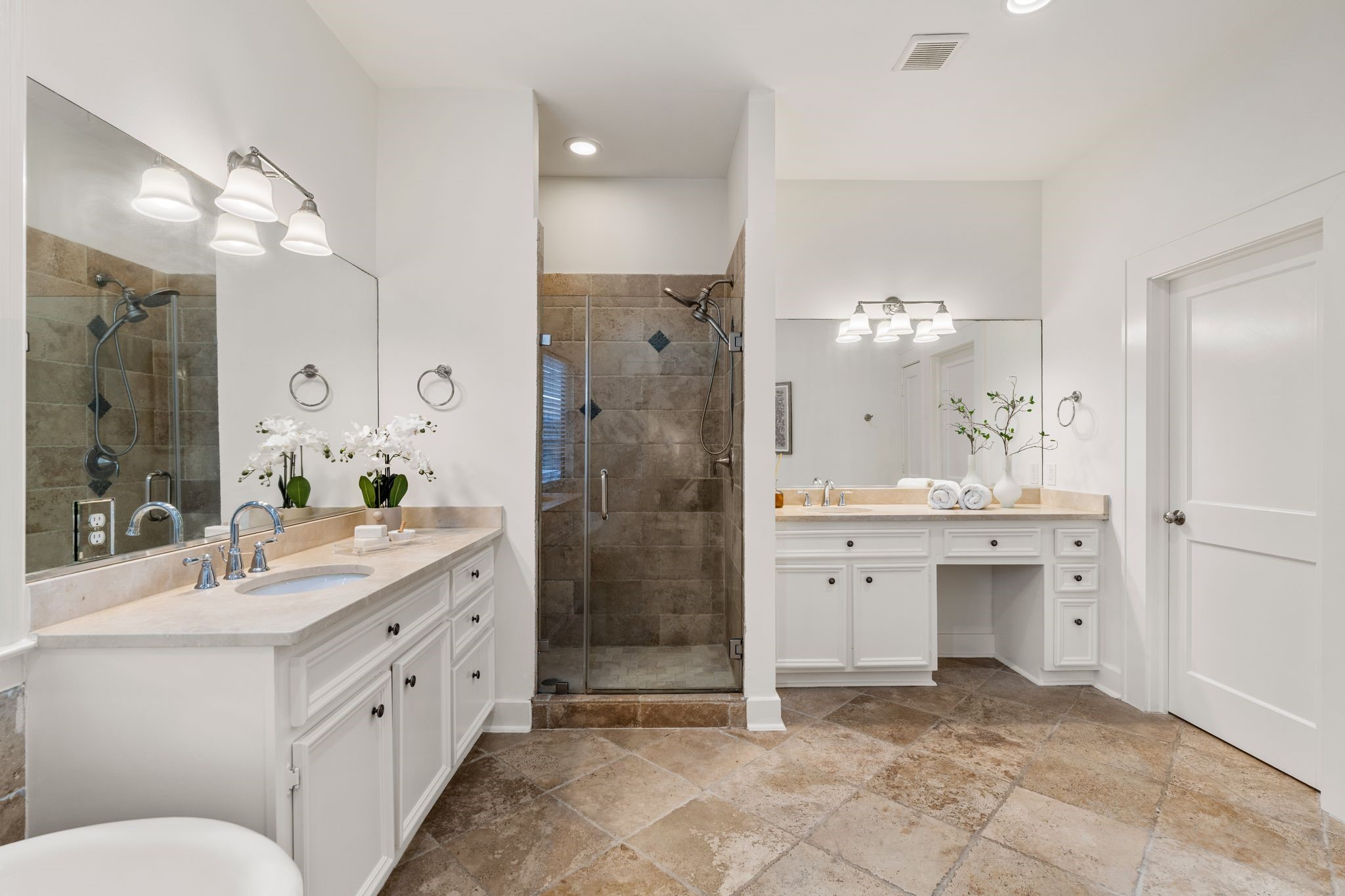 307 East 8th Street Houston, TX 77007 - Photo 16 of 35 Spacious, spa-inspired primary bathroom designed for both comfort and functionality. Features include dual vanities with stone countertops, a dedicated seated makeup vanity, oversized mirrors, vanity and recessed lighting.