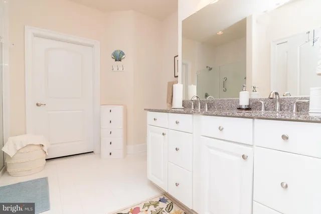 a bathroom with a double vanity sink and mirror