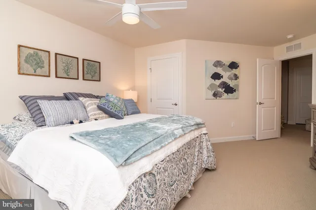 a bedroom with a bed and painting on the wall