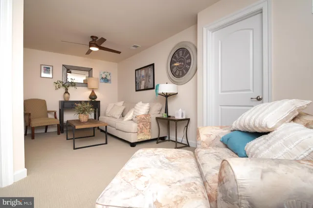 a bedroom with a bed couch and a window