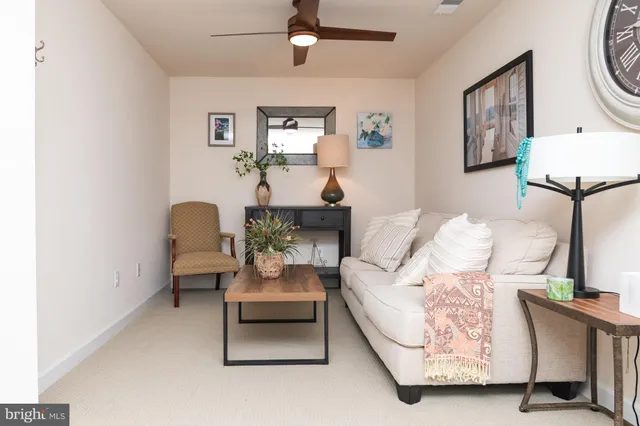 a living room with furniture and a lamp