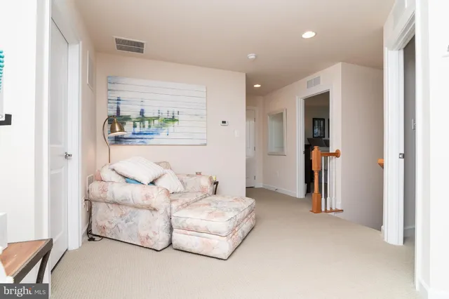 a living room with furniture and a wall painting