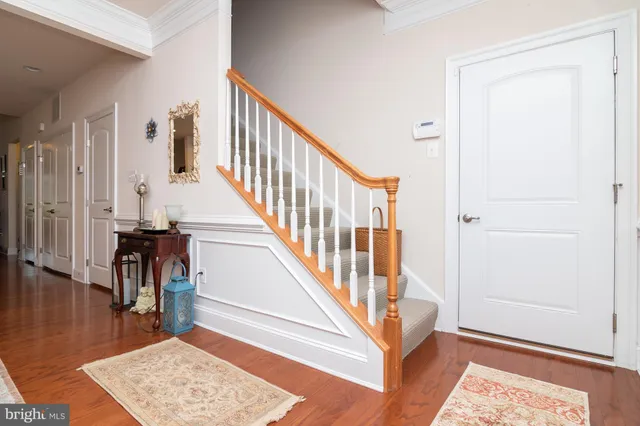 a view of entryway and hall with wooden floor
