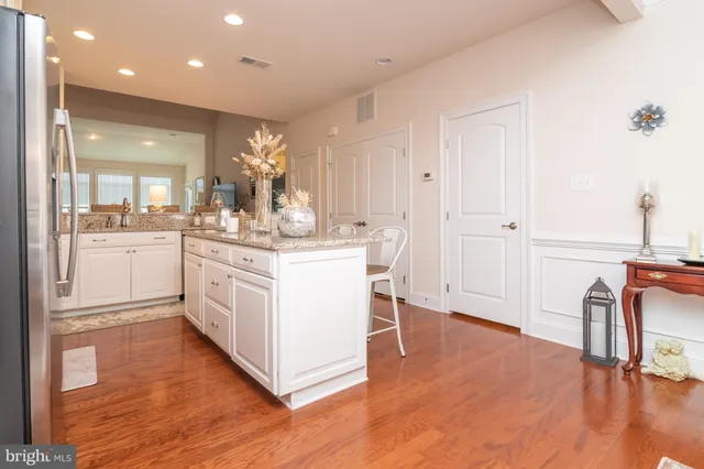 a kitchen with a sink cabinets and wooden floor