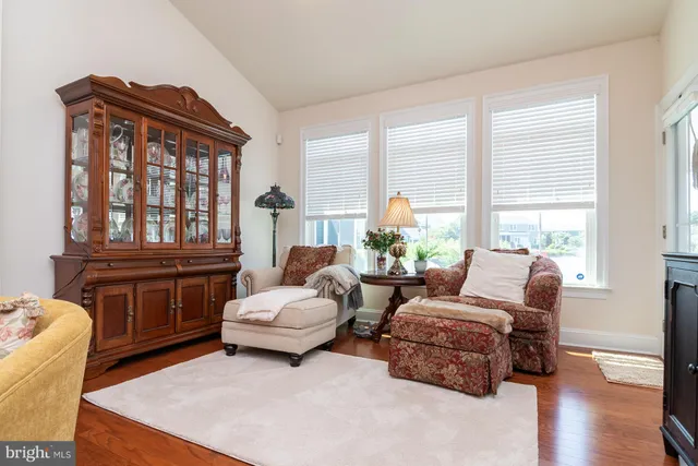 a living room with furniture and large windows