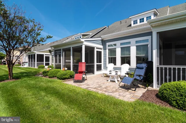 a view of a house with backyard porch and sitting area