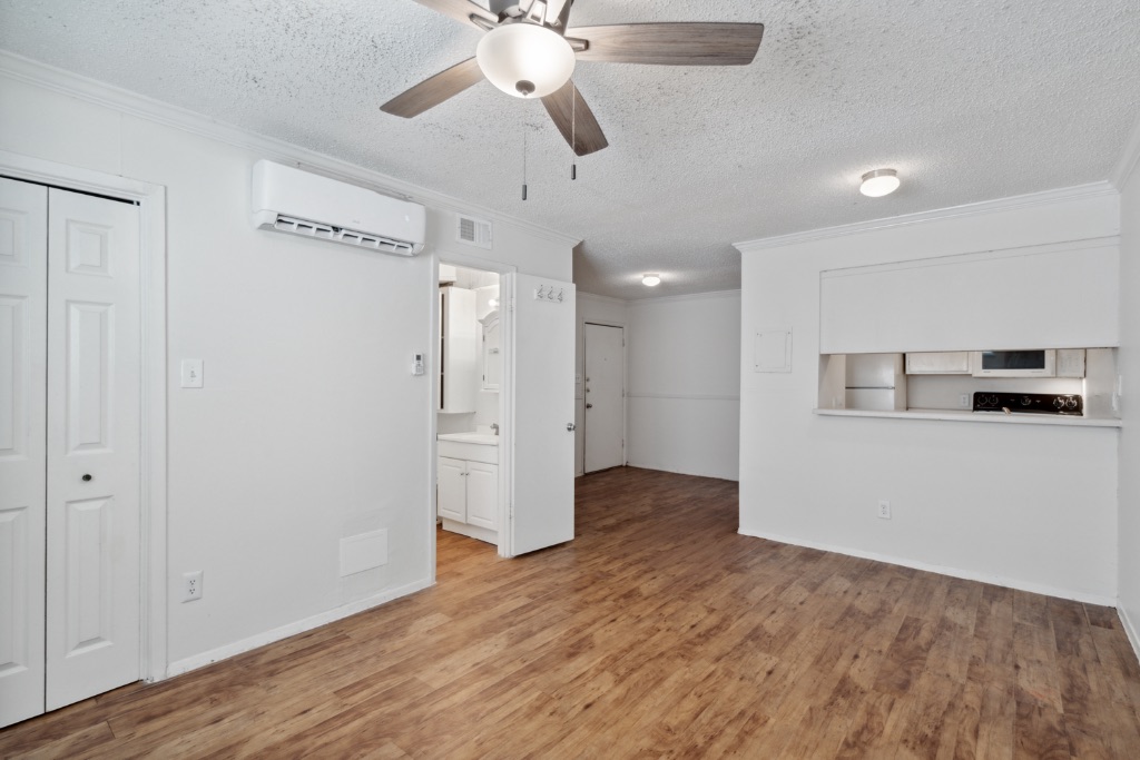 4105 Speedway, Unit 105 Austin, TX 78751 - Photo 1 of 14 a view of an empty room with wooden floor and a ceiling fan
