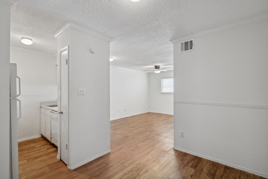 4105 Speedway, Unit 105 Austin, TX 78751 - Photo 2 of 14 a view of an empty room with wooden floor and a bathroom