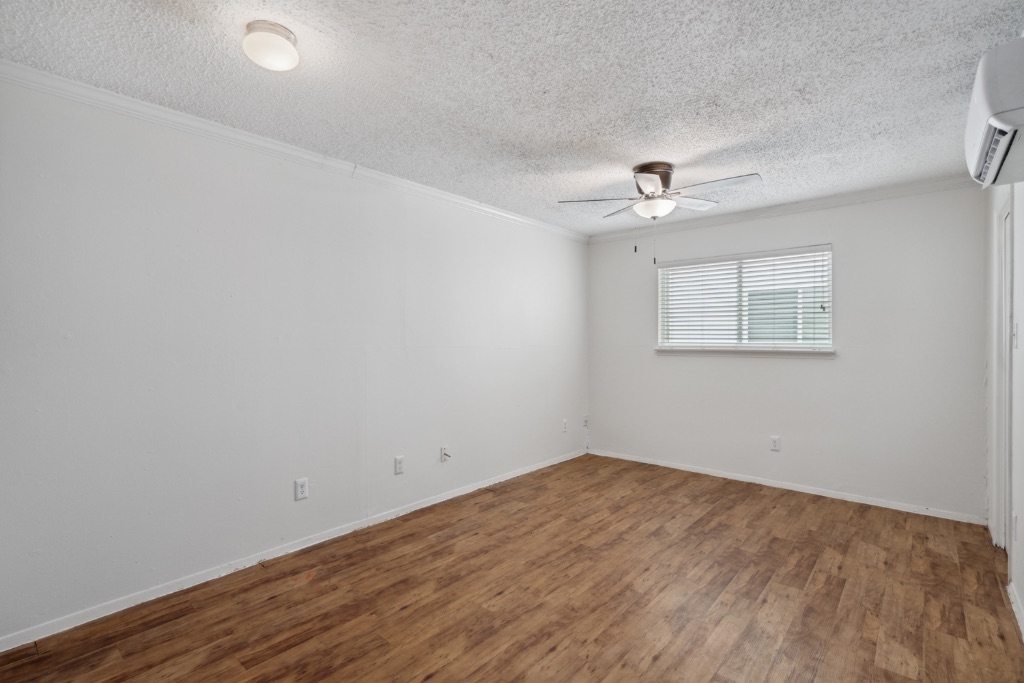 4105 Speedway, Unit 105 Austin, TX 78751 - Photo 4 of 14 wooden floor in an empty room with a window