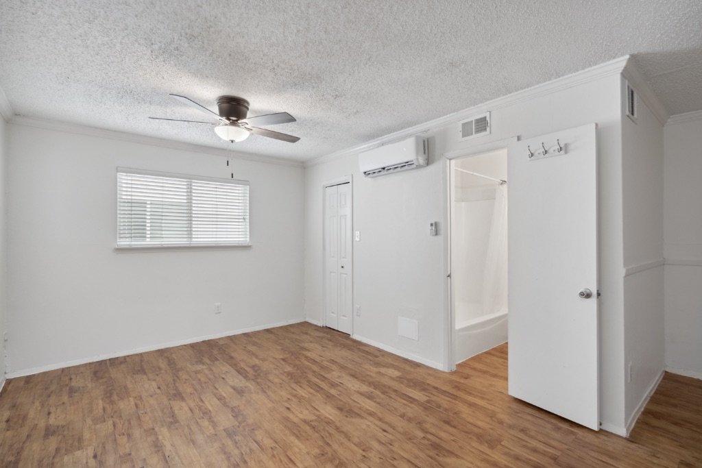 4105 Speedway, Unit 105 Austin, TX 78751 - Photo 5 of 14 a view of a room with wooden floor and a ceiling fan