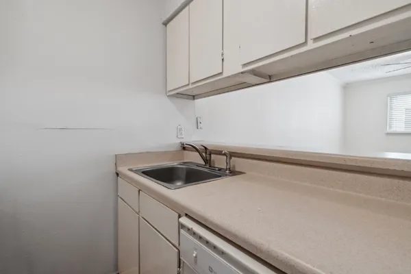 a kitchen with a sink and cabinets