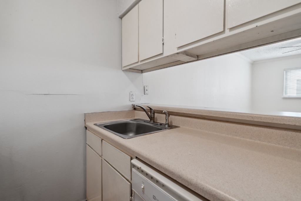 4105 Speedway, Unit 105 Austin, TX 78751 - Photo 8 of 14 a kitchen with a sink and cabinets