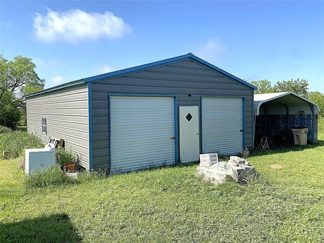 a backyard of a house with yard and garage