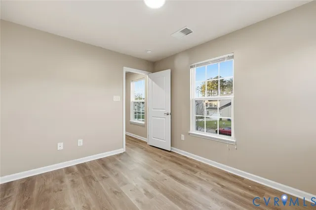 an empty room with windows and closet