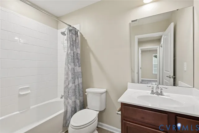 a bathroom with a sink a toilet a mirror a bathtub and shower