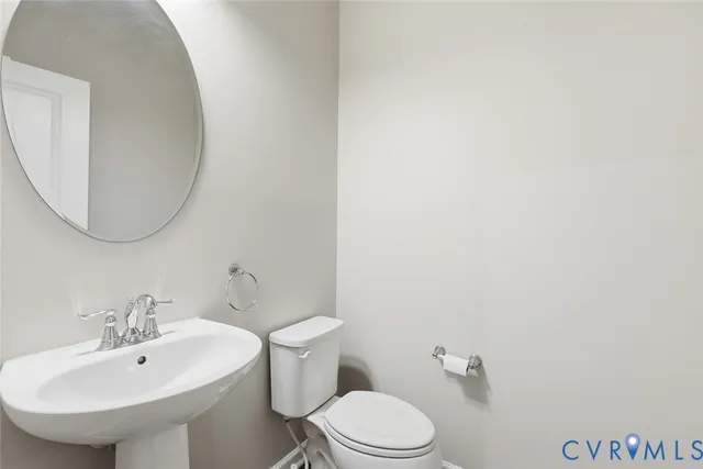 a bathroom with a sink a mirror and a toilet