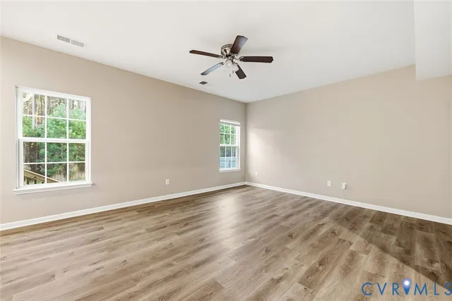 wooden floor in an empty room with a window