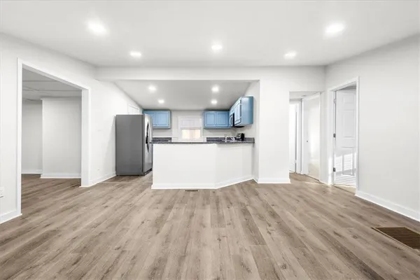 a kitchen with granite countertop a stove top oven sink and cabinets