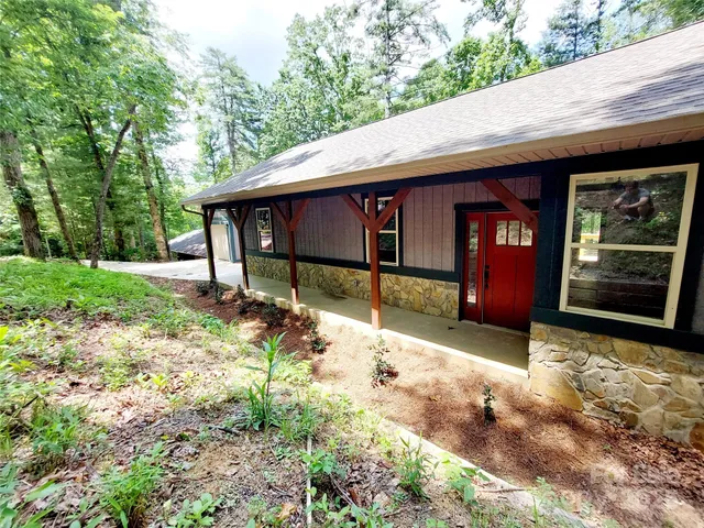 a backyard of a house with yard and trampoline