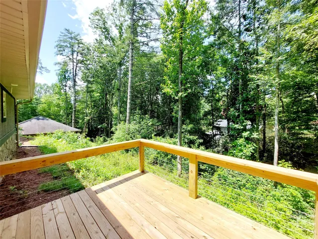 a view of balcony with deck and trees