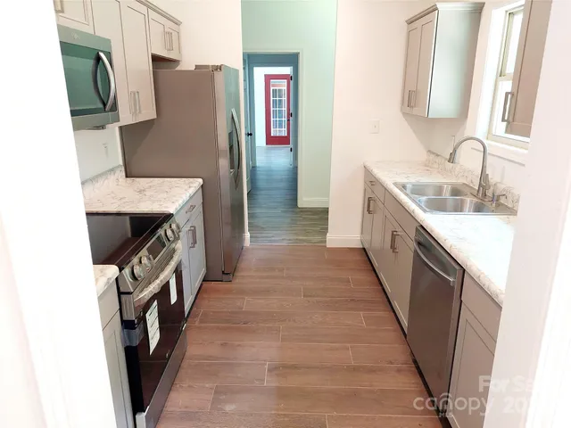 a kitchen with a sink stove and refrigerator