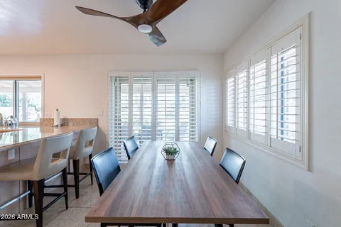 a view of a dining room with furniture a chandelier and wooden floor