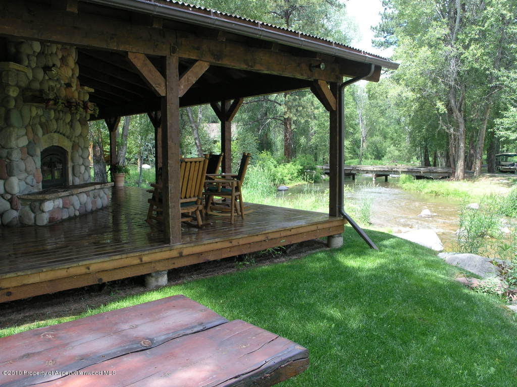 20 Altamira Ranch Road, Unit 1/4 INTEREST Basalt, CO 81621 - Photo 3 of 12 a view of a deck with a table and chairs under an umbrella