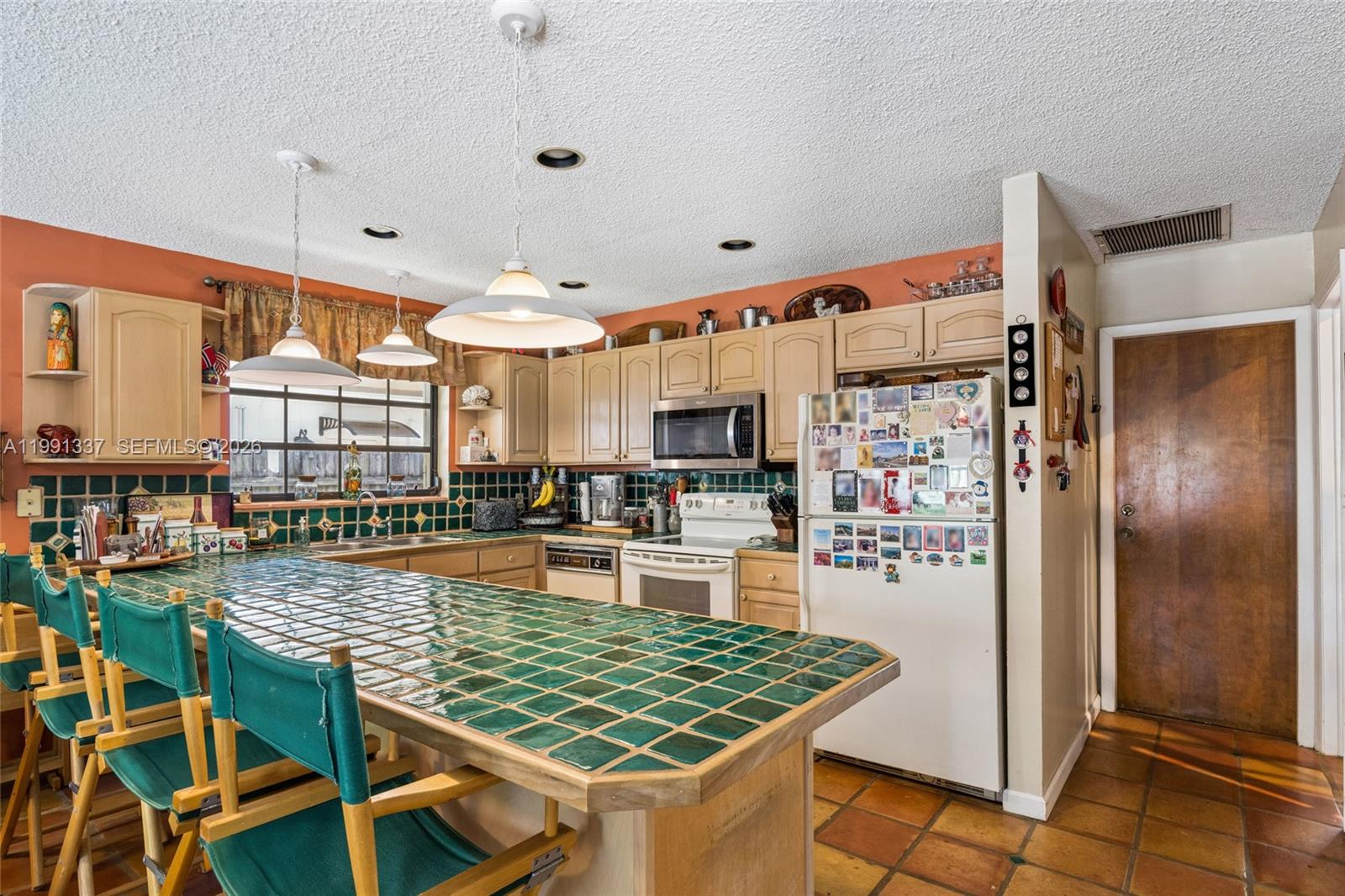 11403 Southwest 129th Place Miami, FL 33186 - Photo 12 of 38 a kitchen with stainless steel appliances granite countertop a refrigerator and a stove top oven