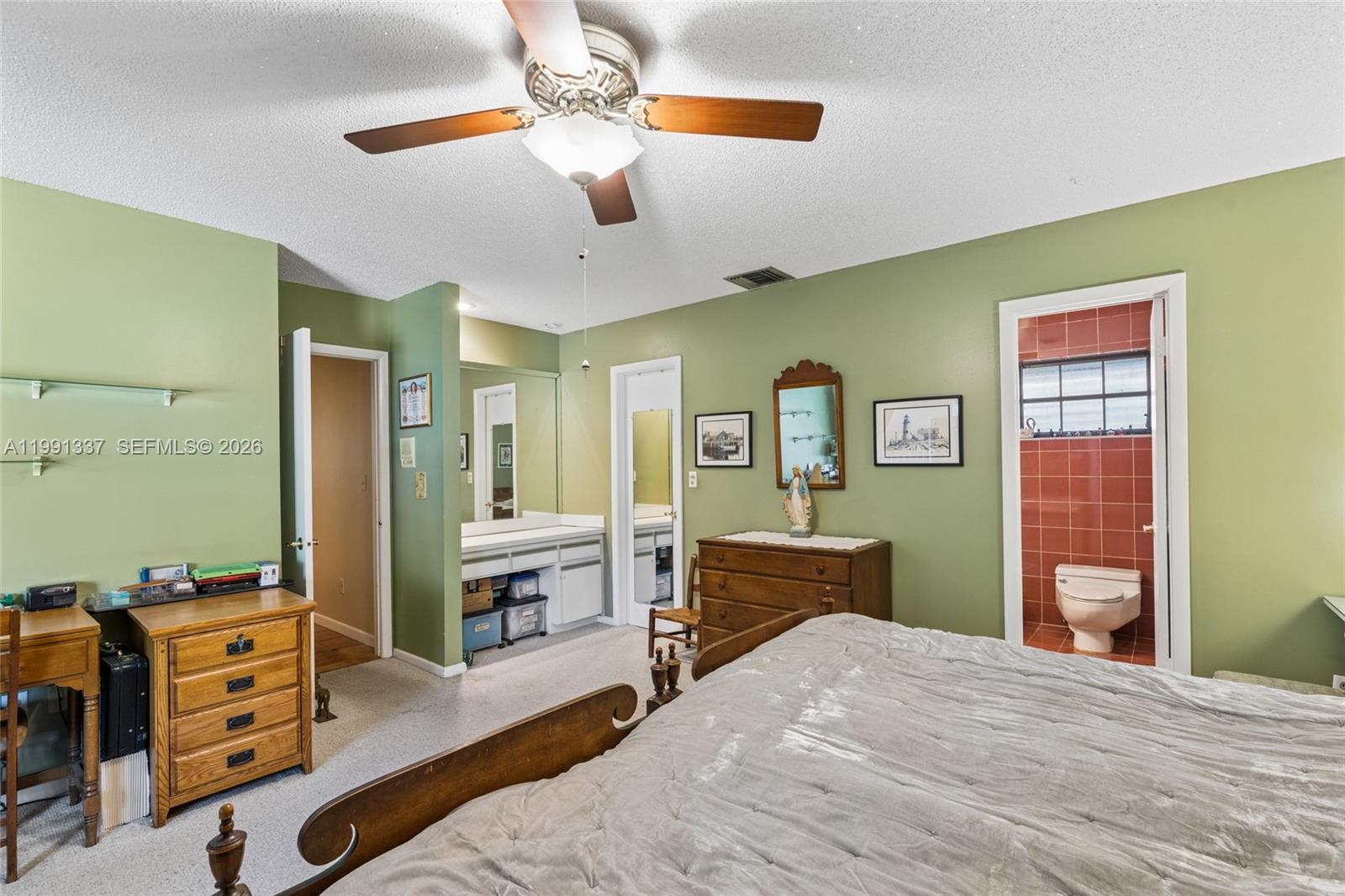 11403 Southwest 129th Place Miami, FL 33186 - Photo 18 of 38 a bedroom with a bed and dresser with mirror